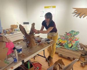 Homer artist Carla Cope crafts a mask at Bunnells Makers Space session on Jan. 28 for parade art construction. (Emilie Springer/Homer News)