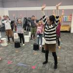 Megumi Beams with members of the West Homer Japanese Club practicing their routine for the Homer Winter Carnival Parade in the West Homer music room on Feb. 2.  Emilie Springer