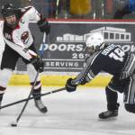 Soldotnas Marshall DeRaeve tries to keep Houstons Afanasy Efimov from clearing the puck at the Division II state hockey tournament Saturday, Feb. 3, 2024, at the Soldotna Regional Sports Complex in Soldotna, Alaska. (Photo by Jeff Helminiak/Peninsula Clarion)