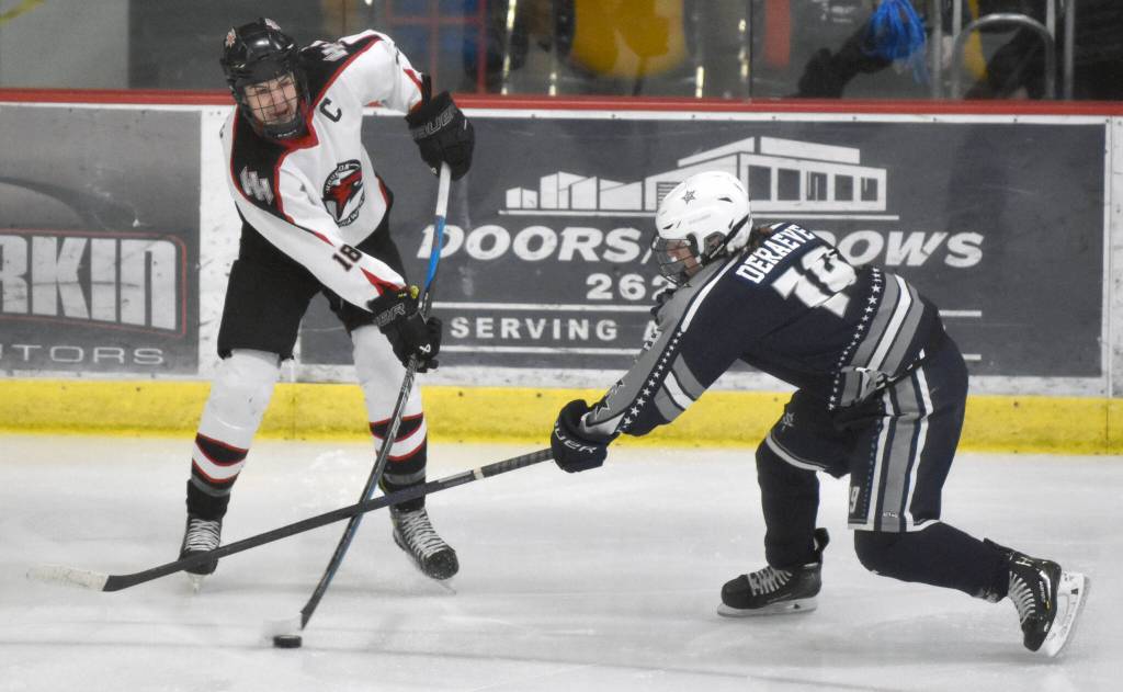 Soldotnas Marshall DeRaeve tries to keep Houstons Afanasy Efimov from clearing the puck at the Division II state hockey tournament Saturday, Feb. 3, 2024, at the Soldotna Regional Sports Complex in Soldotna, Alaska. (Photo by Jeff Helminiak/Peninsula Clarion)