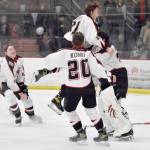 Houston mobs goalie Ari Burnside after winning the Division II state hockey tournament Saturday, Feb. 3, 2024, at the Soldotna Regional Sports Complex in Soldotna, Alaska. (Photo by Jeff Helminiak/Peninsula Clarion)