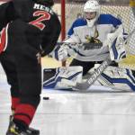 Palmers Keagon OBryan makes a save on Kenai Centrals Logan Mese at the Division II state hockey tournament Saturday, Feb. 3, 2024, at the Soldotna Regional Sports Complex in Soldotna, Alaska. (Photo by Jeff Helminiak/Peninsula Clarion)