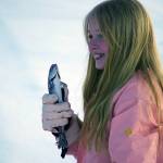 Natalie Kiech, a student of Soldotna Elementary, holds up a rainbow trout she caught during Salmon in the Classroom ice fishing at Sport Lake in Soldotna, Alaska, on Tuesday, Feb. 6, 2024. (Jake Dye/Peninsula Clarion)