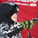 Orion Willis, a student of Soldotna Montessori, holds up a rainbow trout he caught during Salmon in the Classroom ice fishing at Sport Lake in Soldotna, Alaska, on Tuesday, Feb. 6, 2024. (Jake Dye/Peninsula Clarion)