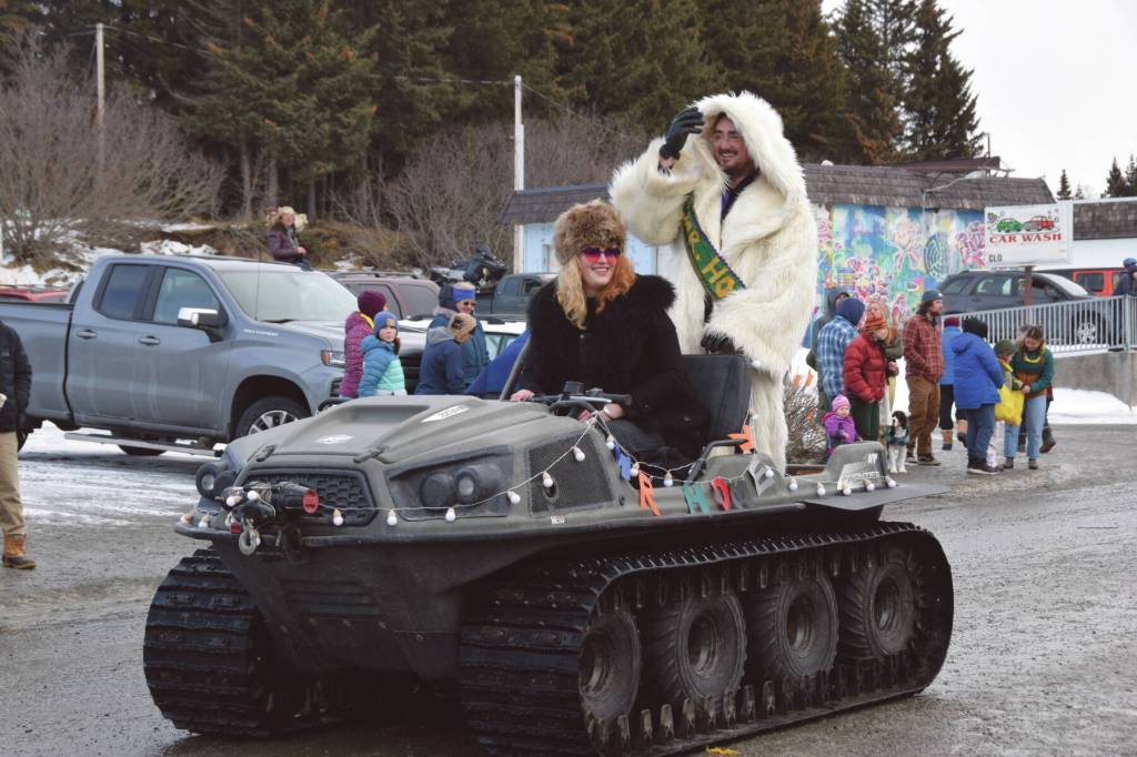 Duncan Hughes, the 2024 Mr. Homer, drives with his wife, Faith Hughes, down Pioneer Avenue at the 70th annual Homer Winter Carnival Parade on Saturday, Feb. 10, 2024 in Homer, Alaska. (Delcenia Cosman/Homer News)