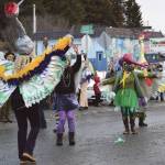 Members of the Krewe of Gambrinus, costumed as sandhill cranes, dance in front of the judges and crowd gathered at the 70th annual Homer Winter Carnival Parade on Pioneer Avenue on Saturday.