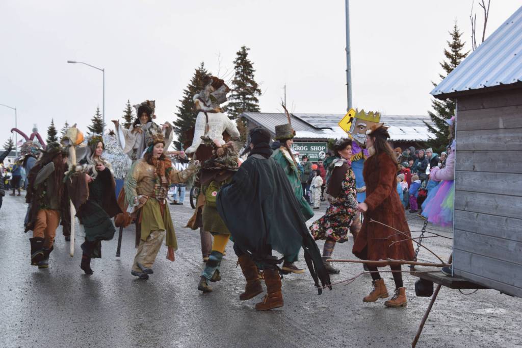 Costumed community members walking with Homer Drawdown outlandishly enliven the 70th annual Homer Winter Carnival Parade on Pioneer Avenue on Saturday, Feb. 10, 2024 in Homer, Alaska with walkable, wearable sculptures created during Bunnell Street Arts Centers January Makers Space sessions. (Delcenia Cosman/Homer News)