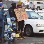 Spectators hold a Grubby for Prez sign, referring to Homers beloved Grubby the Virginia opossum, at the 70th annual Homer Winter Carnival Parade on Pioneer Avenue on Saturday.