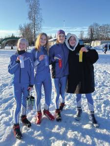 Homer Middle School skiers display their ribbons at the Kenai Invitational Meet on Valentines Day, 2023.  From left to right: Freya Bartlett, Myra Kalafut, Etta Bynagle and Abby Ostrom.