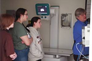 Michelle Duffield/Peninsula Clarion
Jylann Green, Aaliyah Bookey and Isabel Thomas watch Dr. Curt Wisnewski as he shows off some x-rays at Kenai Veterinary Hospital in Kenai on Tuesday.