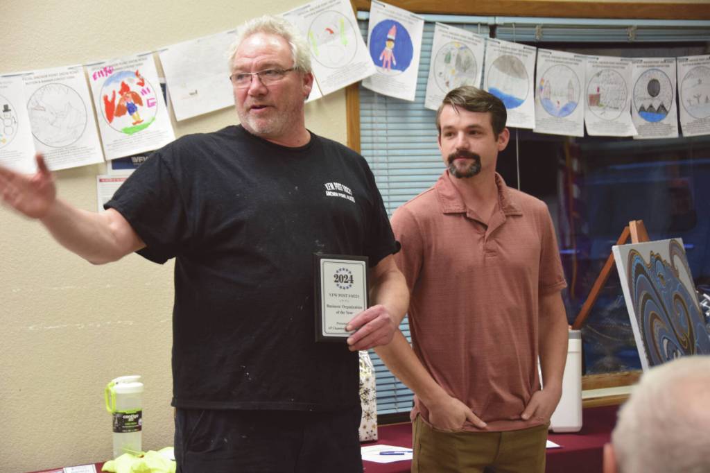 Commander Chuck Collins (left) accepts the Business of the Year award on behalf of the VFW Post 10221 during the Community Awards ceremony on Saturday<ins>, March 2, 2024 at the VFW in Anchor Point, Alaska</ins>. (Delcenia Cosman/Homer News)
