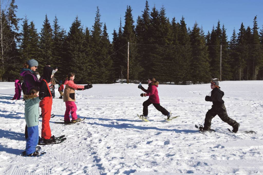 Anchor Point youth run a relay during the Snow Rondi kids snowshoe races on Saturday, March 2<ins>, 2024</ins> at Fireweed Meadows golf course<ins> in Anchor Point, Alaska</ins>. (Delcenia Cosman/Homer News)