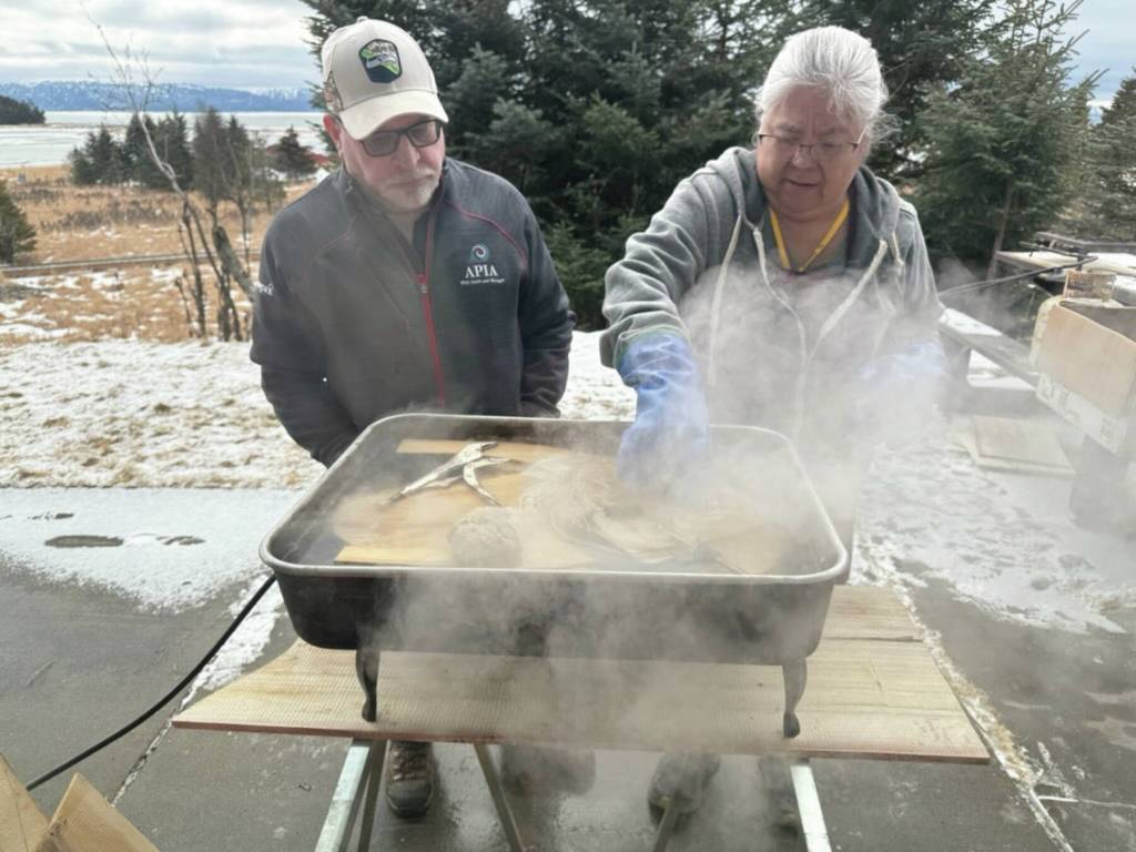 Photo provided by Karyn Murphy
Patty Lekanoff-Gregory and her husband Dave bathe the hats in hot water to make the wood pliable outside of the lab at Islands and Oceans.