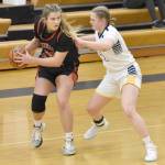 Kenai Centrals Emma Beck holds the ball against Homers Sydney Shelby on Saturday, March 9, 2024, at the Peninsula Conference tournament at Homer High School in Homer, Alaska. (Photo by Jeff Helminiak/Peninsula Clarion)