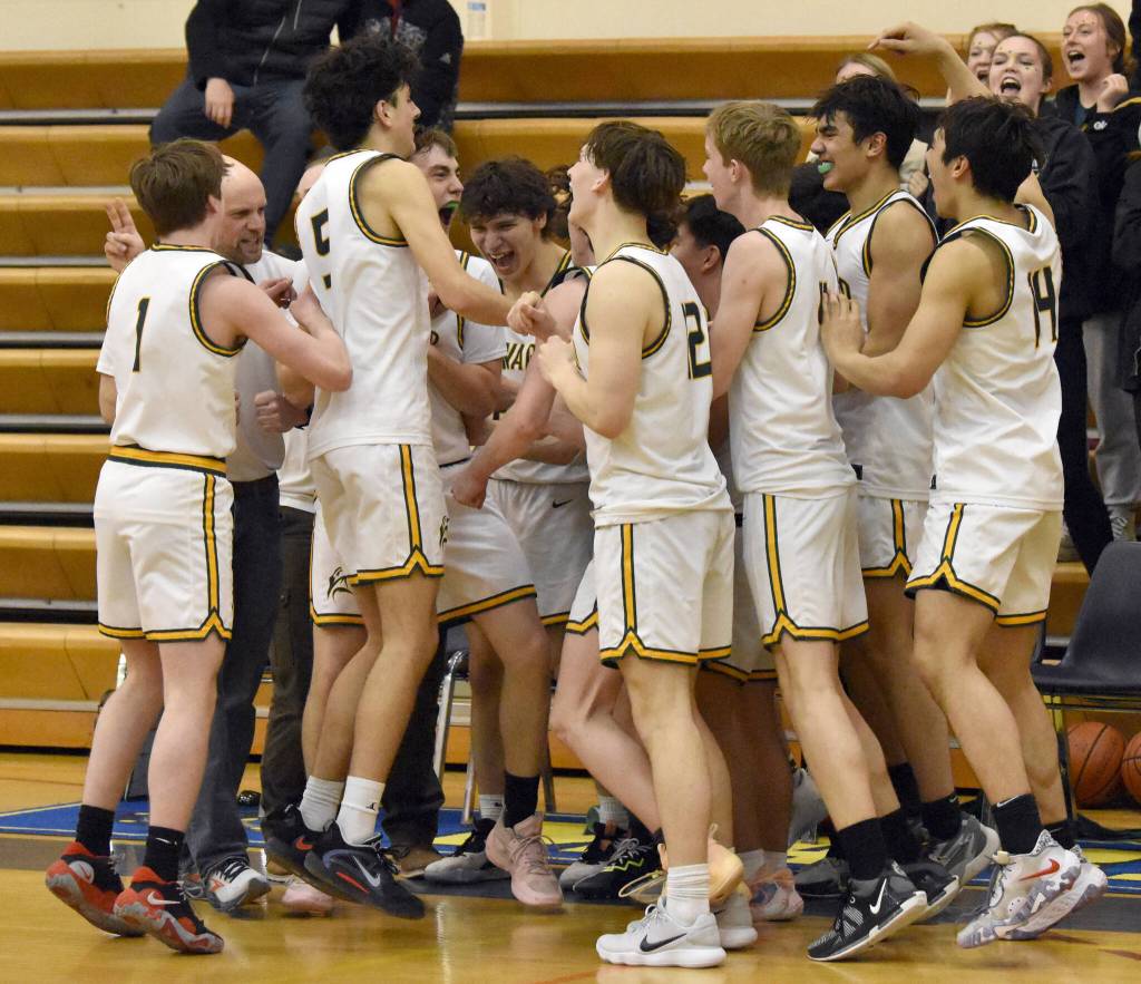The Seward boys celebrate winning second place and getting a Class 3A state berth Saturday, March 9, 2024, at the Peninsula Conference tournament at Homer High School in Homer, Alaska. (Photo by Jeff Helminiak/Peninsula Clarion)