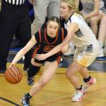 Kenai Centrals Sierra Hershberger dribbles against Homers Minadora Reutov on Saturday, March 9, 2024, at the Peninsula Conference tournament at Homer High School in Homer, Alaska. (Photo by Jeff Helminiak/Peninsula Clarion)