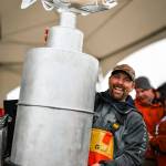 Chris Keithley, 2024 Homer Winter King Salmon Tournament champion, hoists up the new championship trophy crafted by Bay Weld Boats after the awards ceremony at the Deep Water Dock on the Spit in Homer, Alaska on Saturday, March 23, 2024. Photo by Misty Kincaid.