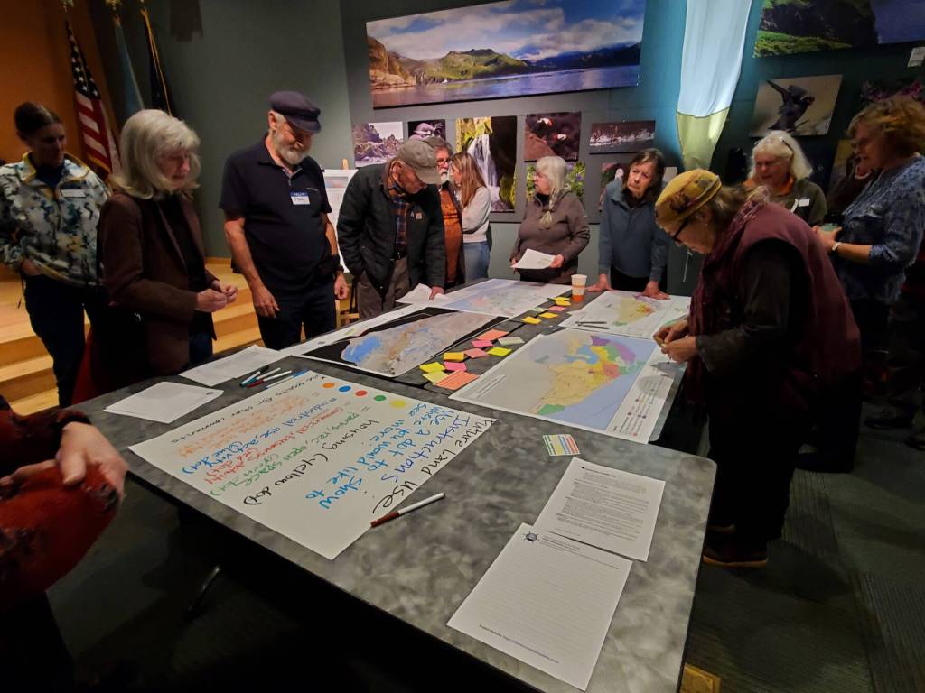 Attendees of the Comprehensive Plan Open House give feedback on future land use in Homer on Thursday, March 28, 2024 at the Alaska Maritime National Wildlife Refuge Visitor Center auditorium in Homer, Alaska. (Delcenia Cosman/Homer News)