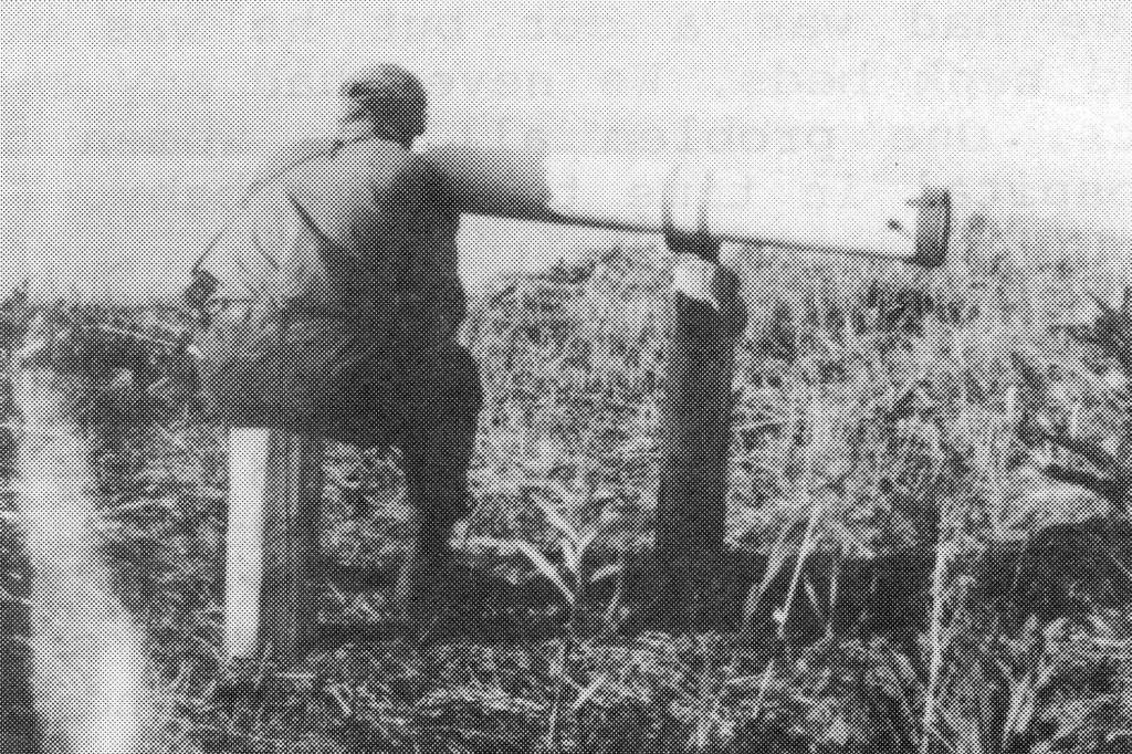 Happy Valley homesteader Wayne Jones looks through the telescope built by Rex Hanks, circa 1950. (Photo from The Pioneers of Happy Valley, 1944-1964, by Ella Mae McGann)