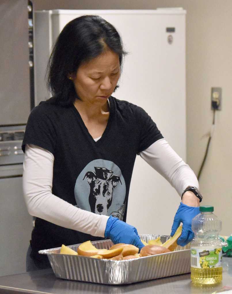 Candace Nakagawa, Co-Director of Sports Science, Strength and Conditioning for the Kenai River Brown Bears, prepares a postgame meal for the team at the Soldotna Regional Sports Complex in Soldotna, Alaska, on Friday, March 29, 2024. (Photo by Jeff Helminiak/Peninsula Clarion)