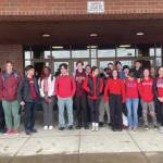 Homer High School students who joined schools from around the state in a high school walkout pose near the end of the event, on Thursday, April 4, 2024, in Homer, Alaska. Not all students who attended the event are in the image. (Photo by Emilie Springer/Homer News)