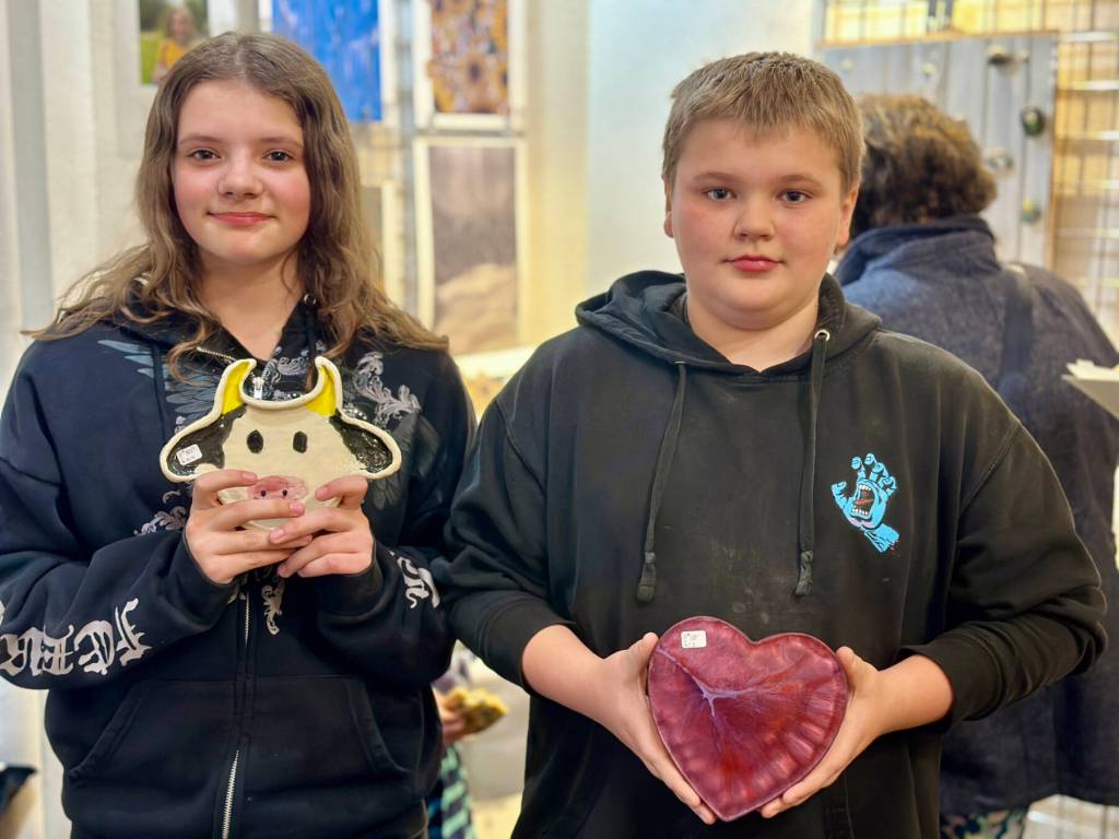 Rileah and Colin Sims, both aged 11, pose with their artwork at Ptarmigan Arts during the gallerys Youth Art Pop Up on Friday, April 5, 2024 in Homer, Alaska. Photo by Christina Whiting