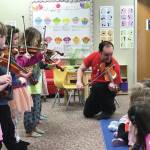 Photo provided by Kim Fine
Fireweed Frescoes share their violin music with pre-school students at the Girassol Learning Center and help them to make cardboard violins on April 5 as part of the Festival of Strings April celebration.