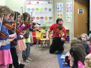 Photo provided by Kim Fine
Fireweed Frescoes share their violin music with pre-school students at the Girassol Learning Center and help them to make cardboard violins on April 5 as part of the Festival of Strings April celebration.