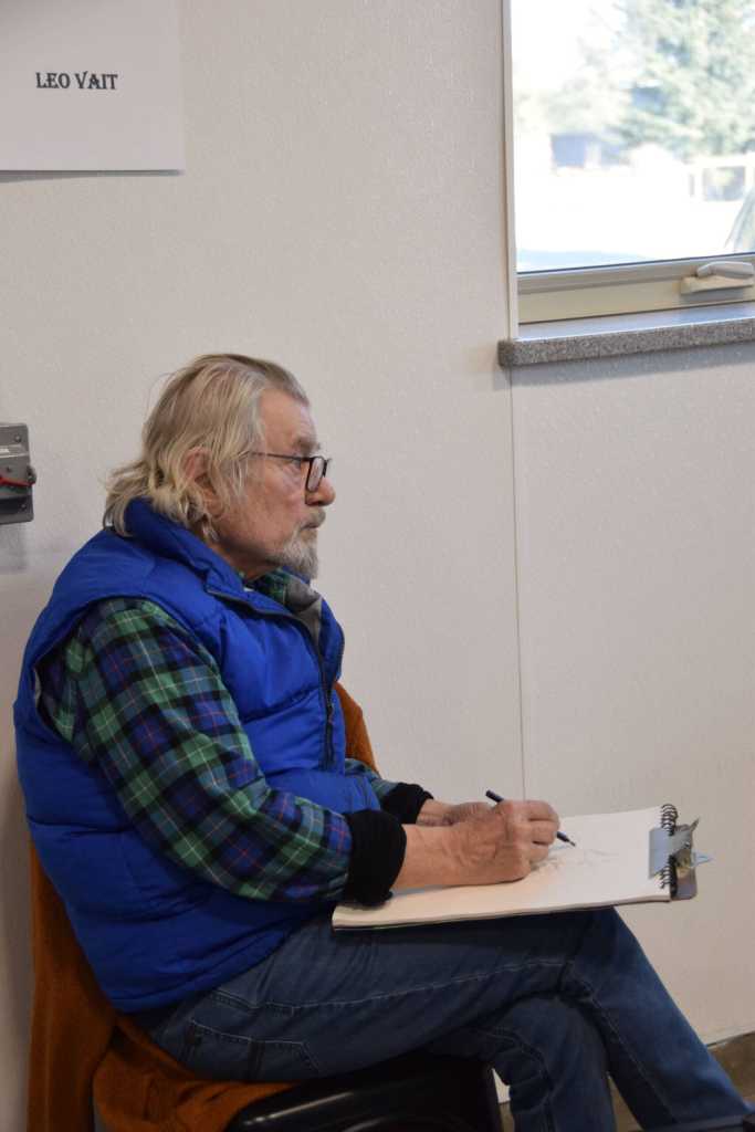Homer artist Leo Vait sketches a portrait of his brother, James Vait, at the Ready, Set, Art! fundraiser, benefiting the Ptarmigan Arts Visual Arts Scholarship Fund, on Saturday, April 13, 2024 at Grace Ridge Brewery in Homer, Alaska. (Delcenia Cosman/Homer News)