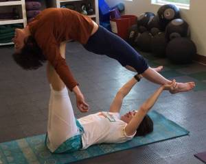 Joolee Aurand, on bottom, demonstrates a yoga pose in this undated photo taken in Homer, Alaska. (Photo provided)