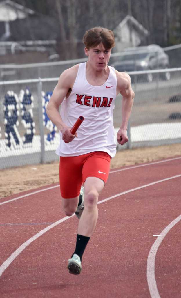 Kenai Centrals Greg Fallon runs in the 1,600-meter relay Saturday, April 20, 2024, at the Soldotna Invitational at Soldotna High School in Soldotna, Alaska. (Photo by Jeff Helminiak/Peninsula Clarion)