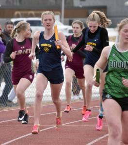 Homers Brightly Thoning hands to Gracie Miotke in the 1,600-meter relay Saturday, April 20, 2024, at the Soldotna Invitational at Soldotna High School in Soldotna, Alaska. (Photo by Jeff Helminiak/Peninsula Clarion)