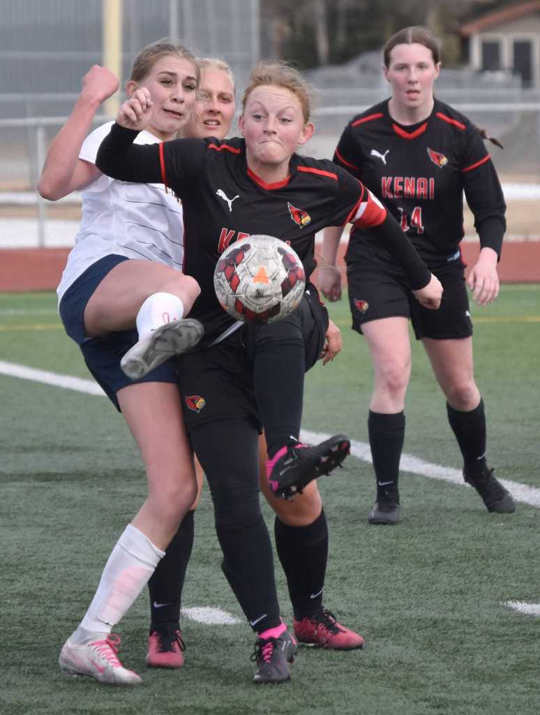 Homers Ruby Hill and Kenai Centrals Kylee Verkuilen battle for the ball Tuesday, April 16, 2024, at Ed Hollier Field at Kenai Central High School in Kenai, Alaska. (Photo by Jeff Helminiak/Peninsula Clarion)