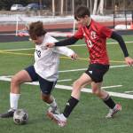 Homers Berend Pearson dribbles against Kenai Centrals Miles Metteer on Tuesday, April 16, 2024, at Ed Hollier Field at Kenai Central High School in Kenai, Alaska. (Photo by Jeff Helminiak/Peninsula Clarion)