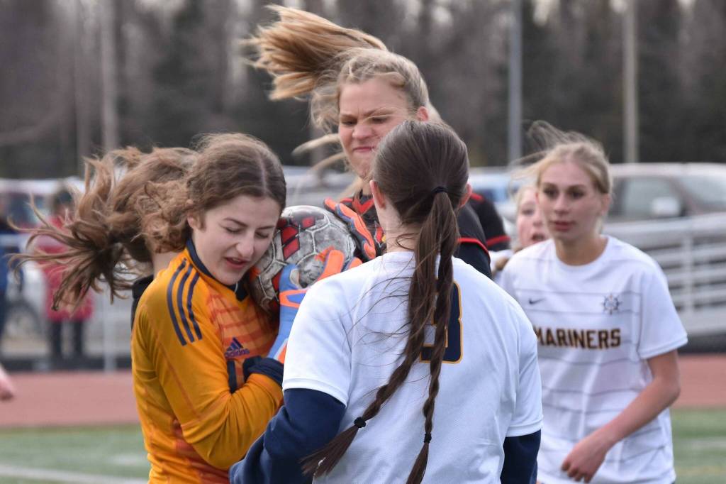 Homer goalie Christi Weisser keeps the ball from Kenai Central's Katie Johnson on Tuesday, April 16, 2024, at Ed Hollier Field at Kenai Central High School in Kenai, Alaska. (Photo by Jeff Helminiak/Peninsula Clarion)