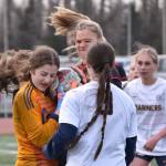 Homer goalie Christi Weisser keeps the ball from Kenai Centrals Katie Johnson on Tuesday, April 16, 2024, at Ed Hollier Field at Kenai Central High School in Kenai, Alaska. (Photo by Jeff Helminiak/Peninsula Clarion)