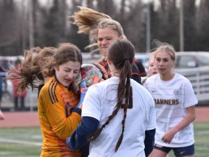 Homer goalie Christi Weisser keeps the ball from Kenai Centrals Katie Johnson on Tuesday, April 16, 2024, at Ed Hollier Field at Kenai Central High School in Kenai, Alaska. (Photo by Jeff Helminiak/Peninsula Clarion)