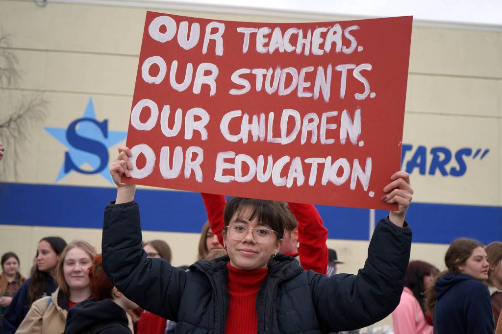 Caitlin Babcock joins other students of Soldotna High School as they stage a walkout in protest of the veto of Senate Bill 140 in front of their school in Soldotna, Alaska, on Wednesday, April 17, 2024. (Jake Dye/Peninsula Clarion)