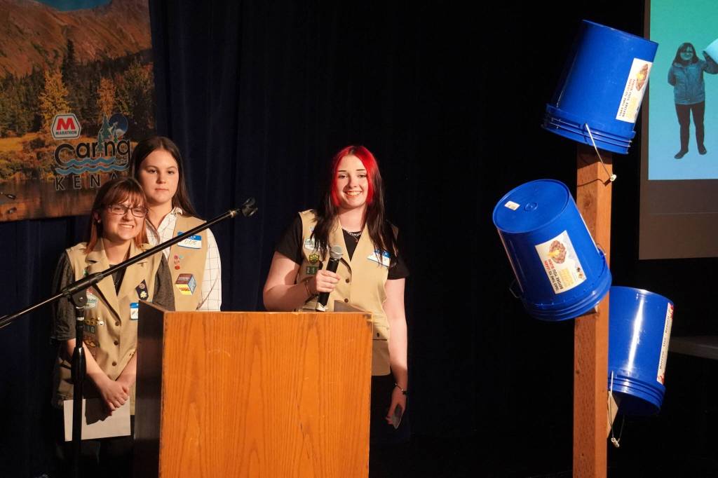 Girl Scout Troop 210, which includes Caitlyn Eskelin, Emma Hindman, Kadie Newkirk and Lyberty Stockman, present their Bucket Trees to a panel of judges in the 34th Annual Caring for the Kenai Competition at Kenai Central High School in Kenai, Alaska, on Thursday, April 18, 2024. (Jake Dye/Peninsula Clarion)