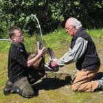 Jason Sodergren and retired veterinarian Ralph Broshes capture and attend to crane shot with an arrow, July 9, 2023, in Homer, Alaska. (Photo provided by Nina Faust)