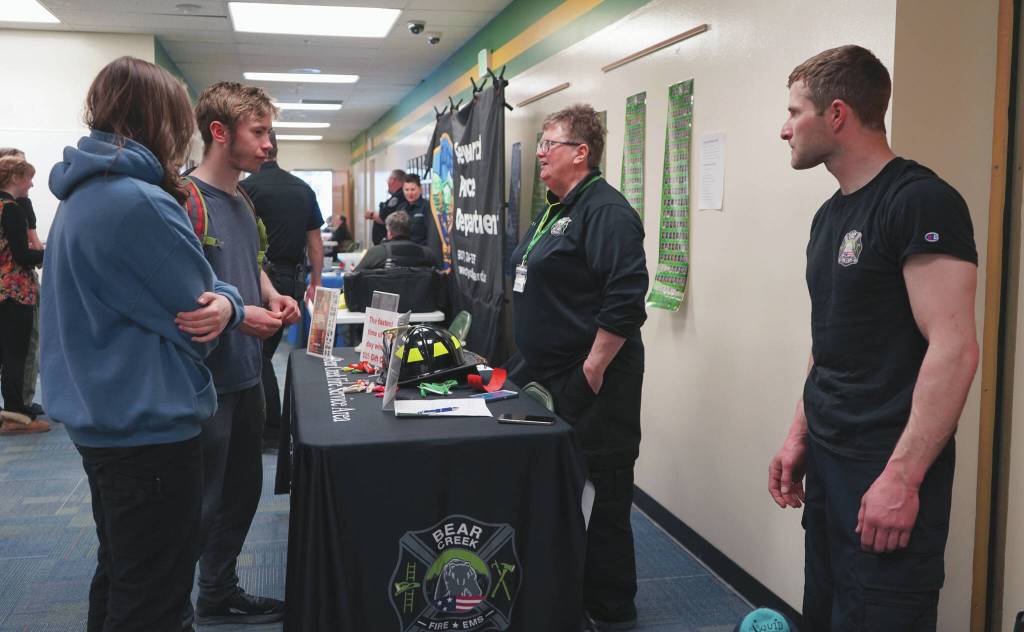 Oliver Trobaugh speaks to representatives of Bear Creek Volunteer Fire Department during Career Day at Seward High School in Seward on Wednesday. (Jake Dye/Peninsula Clarion)