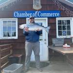 Arthur Schwartz holds up his prize-winning king salmon in front of the Anchor Point Chamber of Commerce building on Saturday, April 27, 2024 in Anchor Point, Alaska. Schwartz, fishing on the Resolute, won first place in the 29th annual Anchor Point King Salmon Derby. (Photo provided by Erin Jerde)