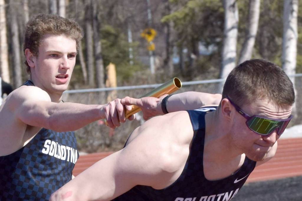 Soldotna's James Innes hands to Jeren Nash on Soldotna's winning 400-meter relay Saturday, April 27, 2024, at the Kenai Invitational at Kenai Central High School in Kenai, Alaska. (Photo by Jeff Helminiak/Peninsula Clarion)
