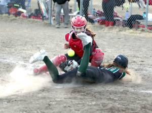 (Bruce Eggleston/matsusports.net) Colonys Kara Macy slides into home safely as the ball bounces in front of Kenai Central catcher Maggie Grenier at the Rally in the Valley tournament Thursday, April 25, 2024, at Colony Middle School in Palmer.