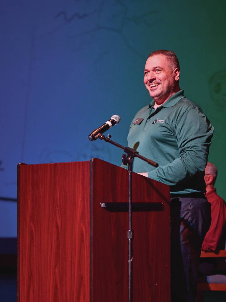 Joe Halstead from HEA's information technology team addresses attendees at the annual public meeting in the Homer High School Theatre on May 2, 2024.  Photo provided by Christopher Kincaid.