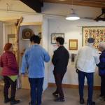 Community members gather at the Pratt Museum on Friday, May 3, 2024 to view the exhibition of art donated to Homer by Teshio, Japan during the sister city 40th anniversary celebration in Homer, Alaska. (Delcenia Cosman/Homer News)