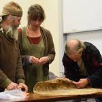 (from left to right) Lasse Holmes, Anna Wolfson and Gordy Vernon form a drum skin by inserting wooden dowls through pre-drilled holes during the free workshop hosted at Kachemak Bay Campus on Friday, May 3, 2024 in Homer, Alaska. (Delcenia Cosman/Homer News)