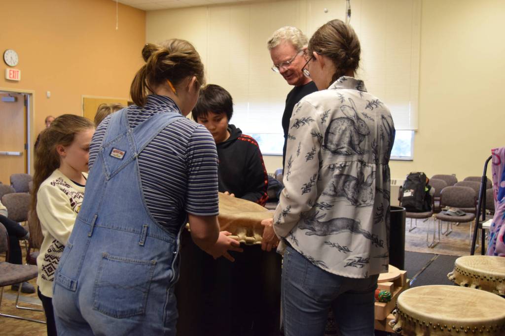 Students of Homers Alaska Japanese Club stretch a formed steerhide skin over a drum base during the free workshop hosted at Kachemak Bay Campus on Friday, May 3, 2024 in Homer, Alaska. (Delcenia Cosman/Homer News)