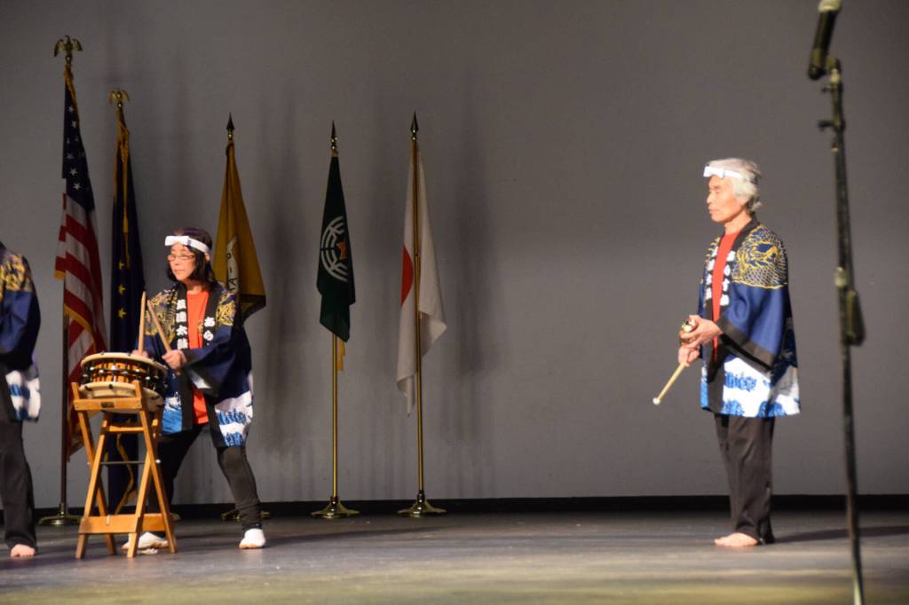 Naoyuki Furuta (right) plays the kane, keeping the beat for the taiko drummers during Tomodachi Daikos performance of Alaska Nokokoro during their first show on Saturday, May 4, 2024 at the Homer High School Mariner Theatre in Homer, Alaska. (Delcenia Cosman/Homer News)