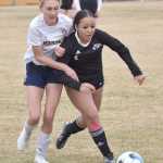 Homers Goldie Hill and Nikiskis Maddie Iyatunguk battle for the ball Saturday, May 4, 2024, at Nikiski Middle-High School in Nikiski, Alaska. (Photo by Jeff Helminiak/Peninsula Clarion)